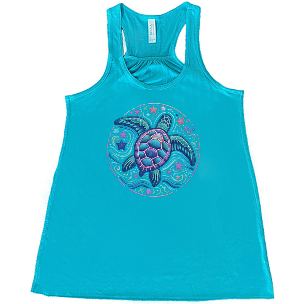 Teal colored flowy tank with a colorful turtle graphic on it