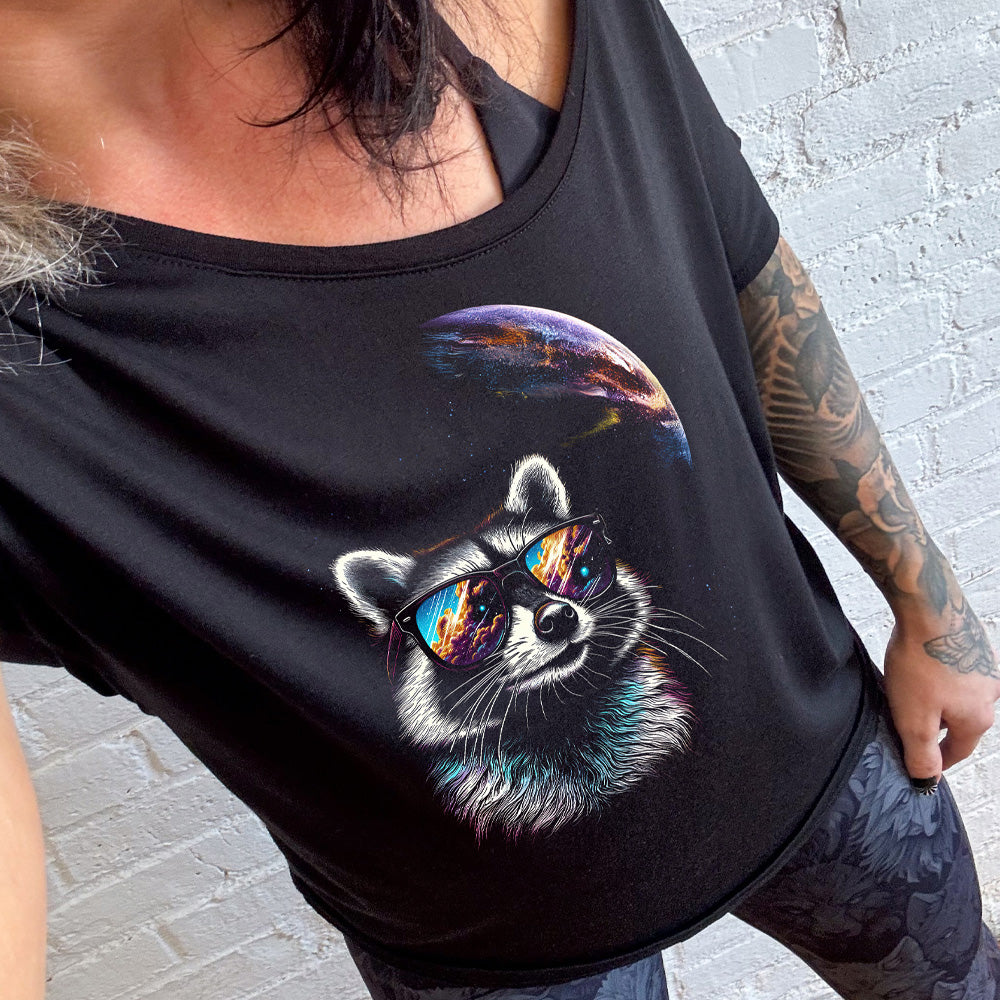 shirt with a raccoon looking into space graphic on it