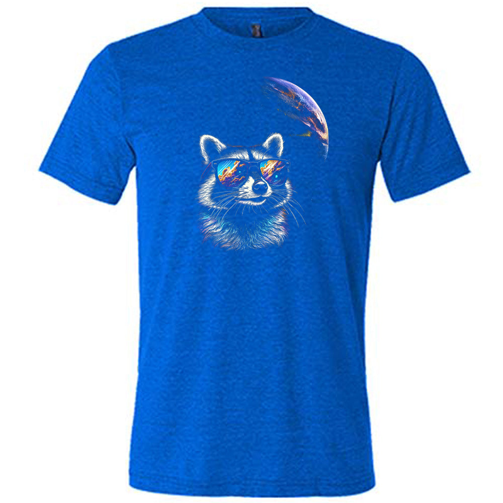 Blue colored shirt with a raccoon looking into space graphic on it