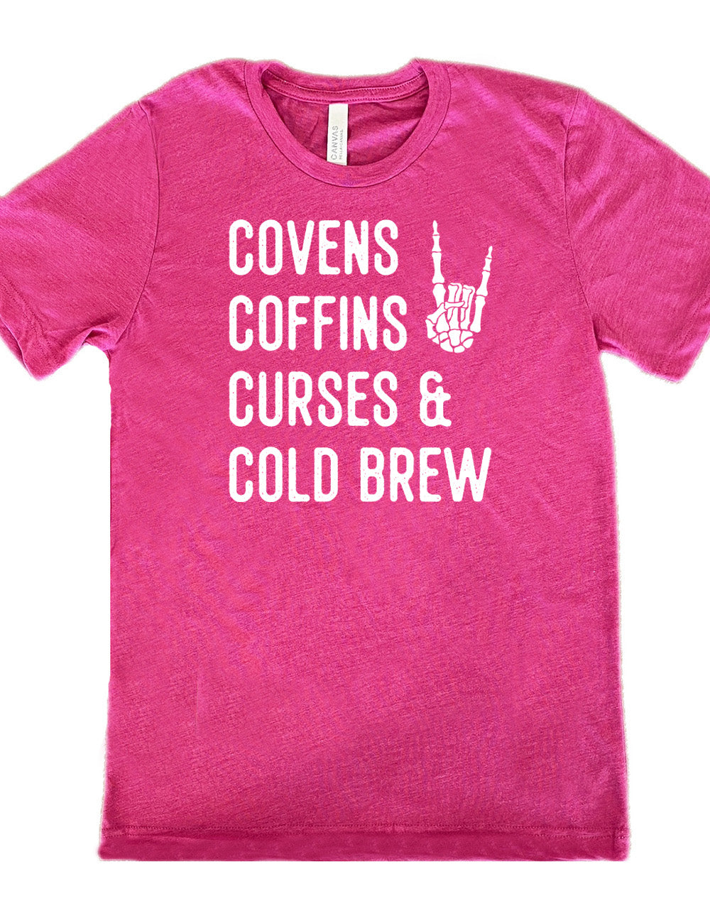 berry unisex tee with the words listed "covens coffins curses & cold brew" and the graphic of a skeletal rocker hand