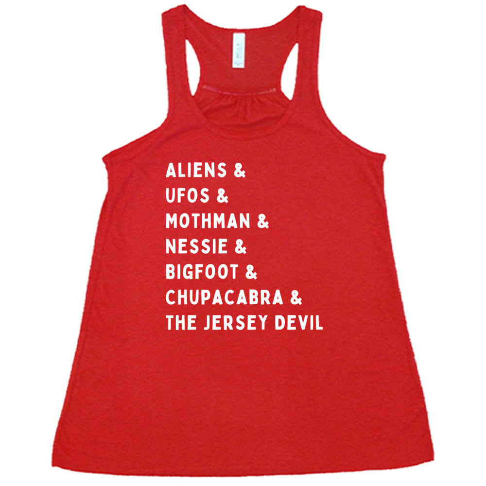 Red colored flowy tank with graphic on it that says "ALIENS & UFOS & MOTHMAN & NESSIE & BIGFOOT & CHUPACABRA & THE JERSEY DEVIL"