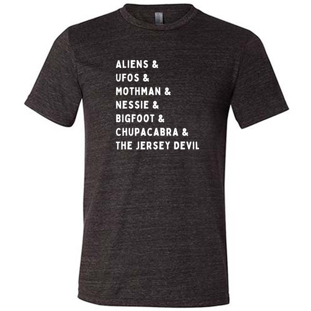Black colored shirt with graphic on it that says "ALIENS & UFOS & MOTHMAN & NESSIE & BIGFOOT & CHUPACABRA & THE JERSEY DEVIL"