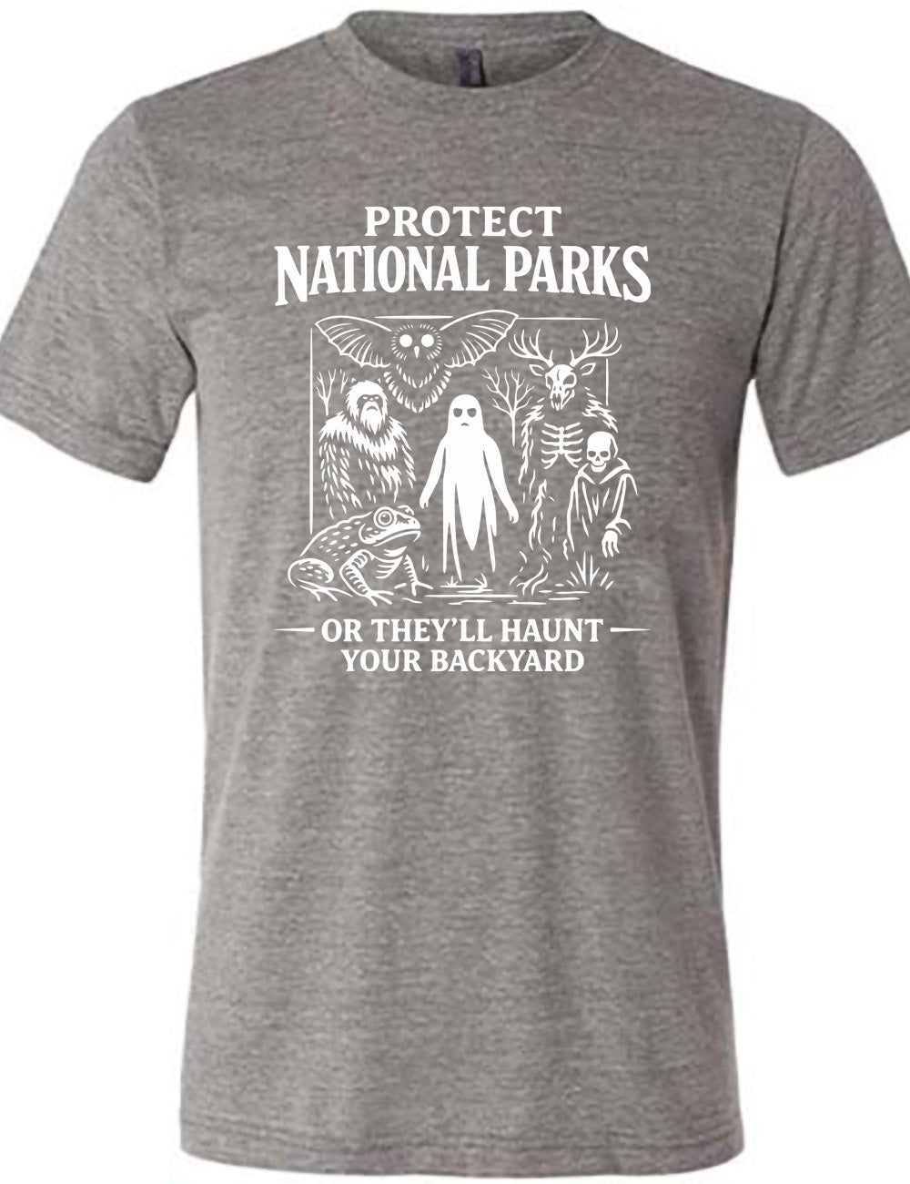 grey unisex tee with the words on it saying "Protect National Parks" and a graphic of various cryptids, and underneath words saying "or they'll haunt your backyard"