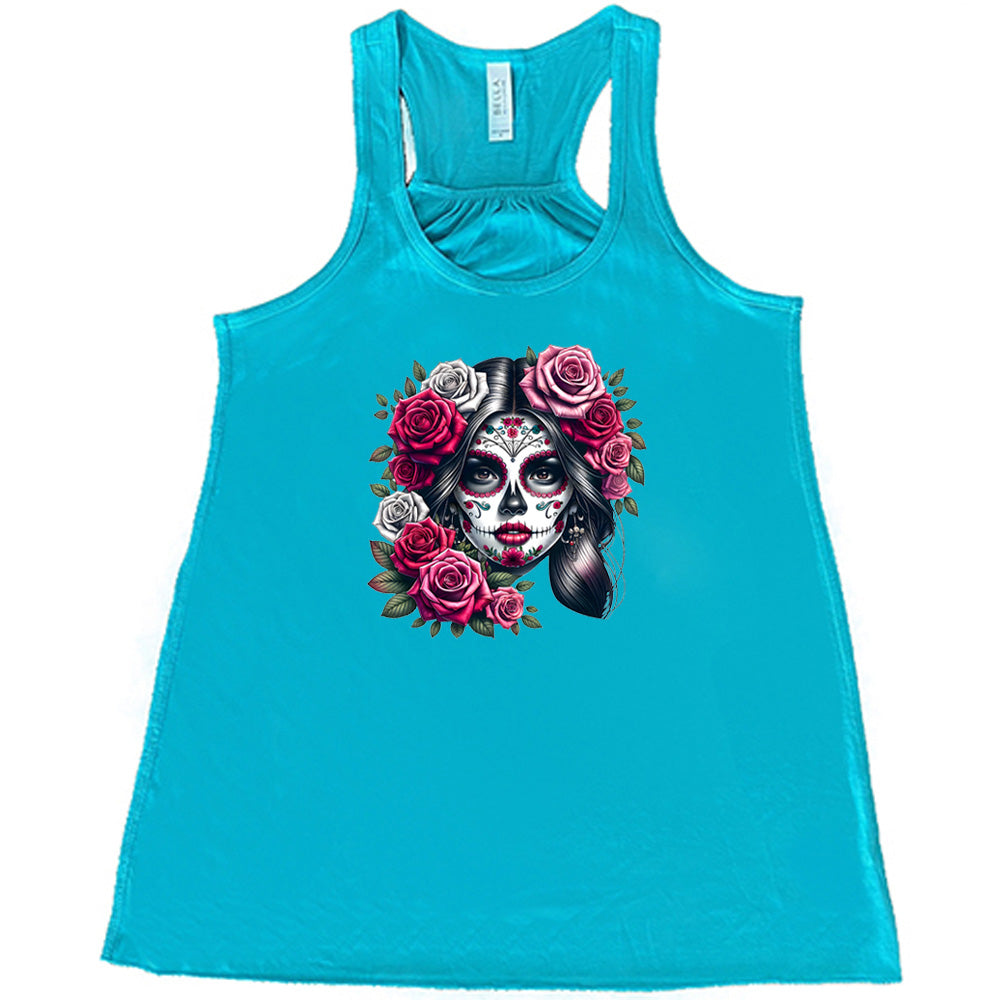 teal shirt with a Day Of The Dead graphic on it