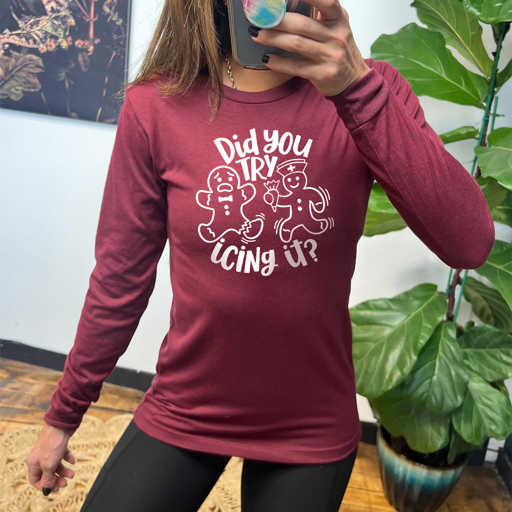 heather cardinal long sleeve with the words "did you try icing it?" in white lettering, with the image of an injured gingerbread person and a doctor gingerbread person running towards them with icing