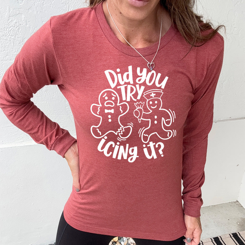 heather clay long sleeve with the words "did you try icing it?" in white lettering, with the image of an injured gingerbread person and a doctor gingerbread person running towards them with icing