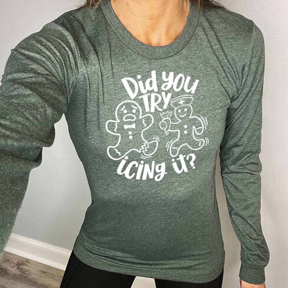heather forest long sleeve with the words "did you try icing it?" in white lettering, with the image of an injured gingerbread person and a doctor gingerbread person running towards them with icing