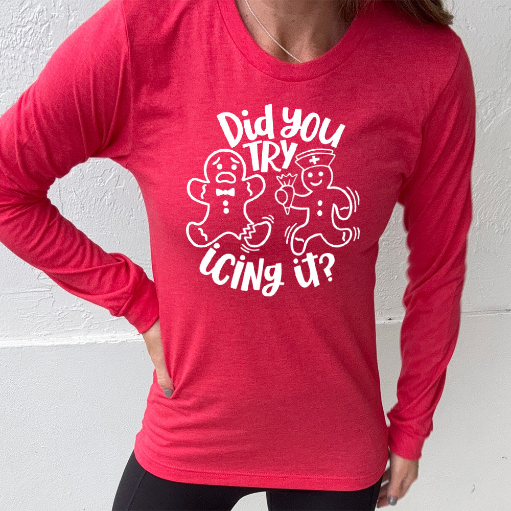 heather red long sleeve with the words "did you try icing it?" in white lettering, with the image of an injured gingerbread person and a doctor gingerbread person running towards them with icing