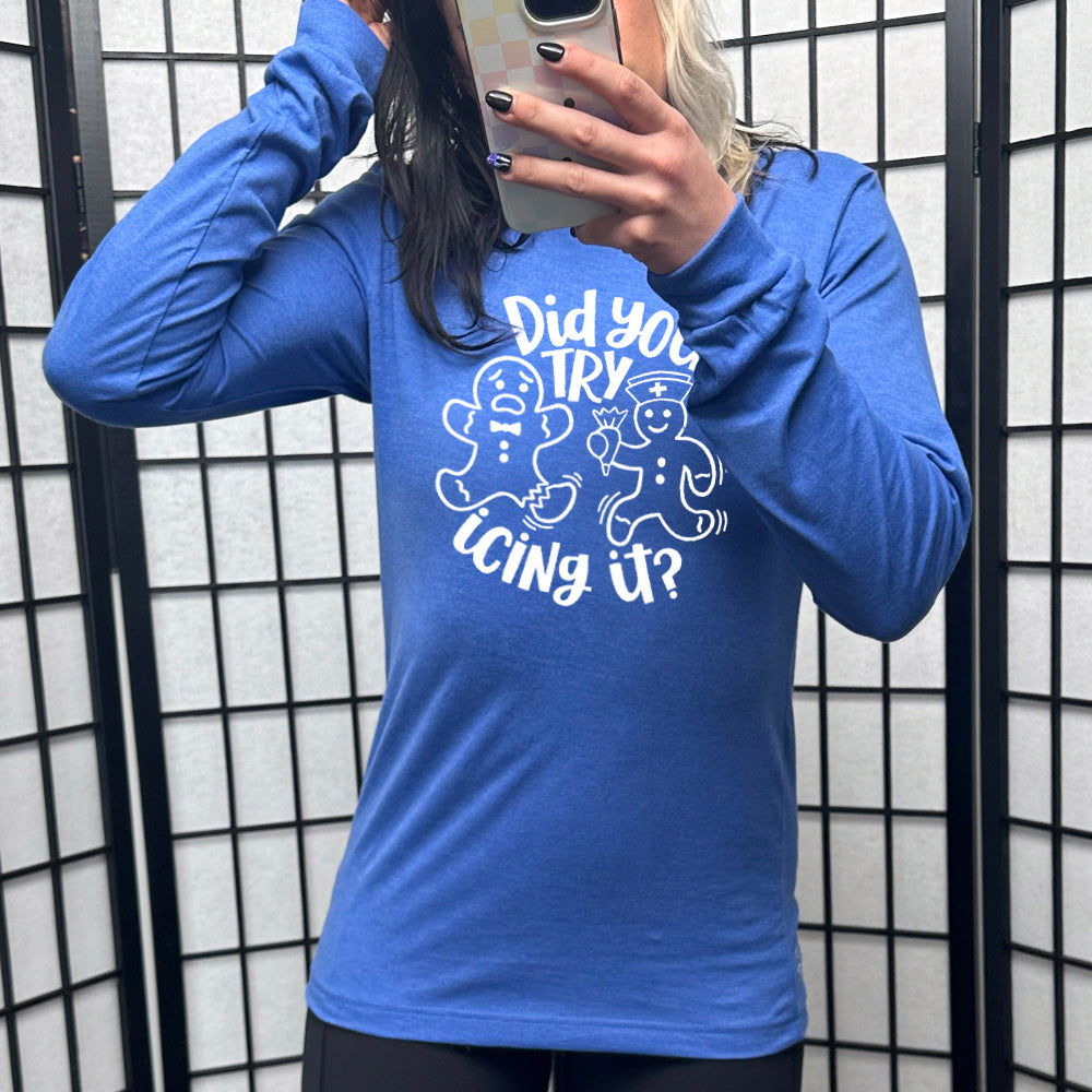 heather royal blue long sleeve with the words "did you try icing it?" in white lettering, with the image of an injured gingerbread person and a doctor gingerbread person running towards them with icing