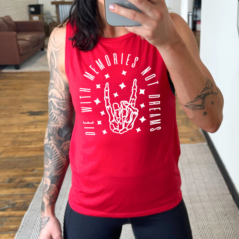 red muscle tank with the graphic of a rocker skeleton hand, surrounded by little stars as well as an archway of text saying "die with memories not dreams"