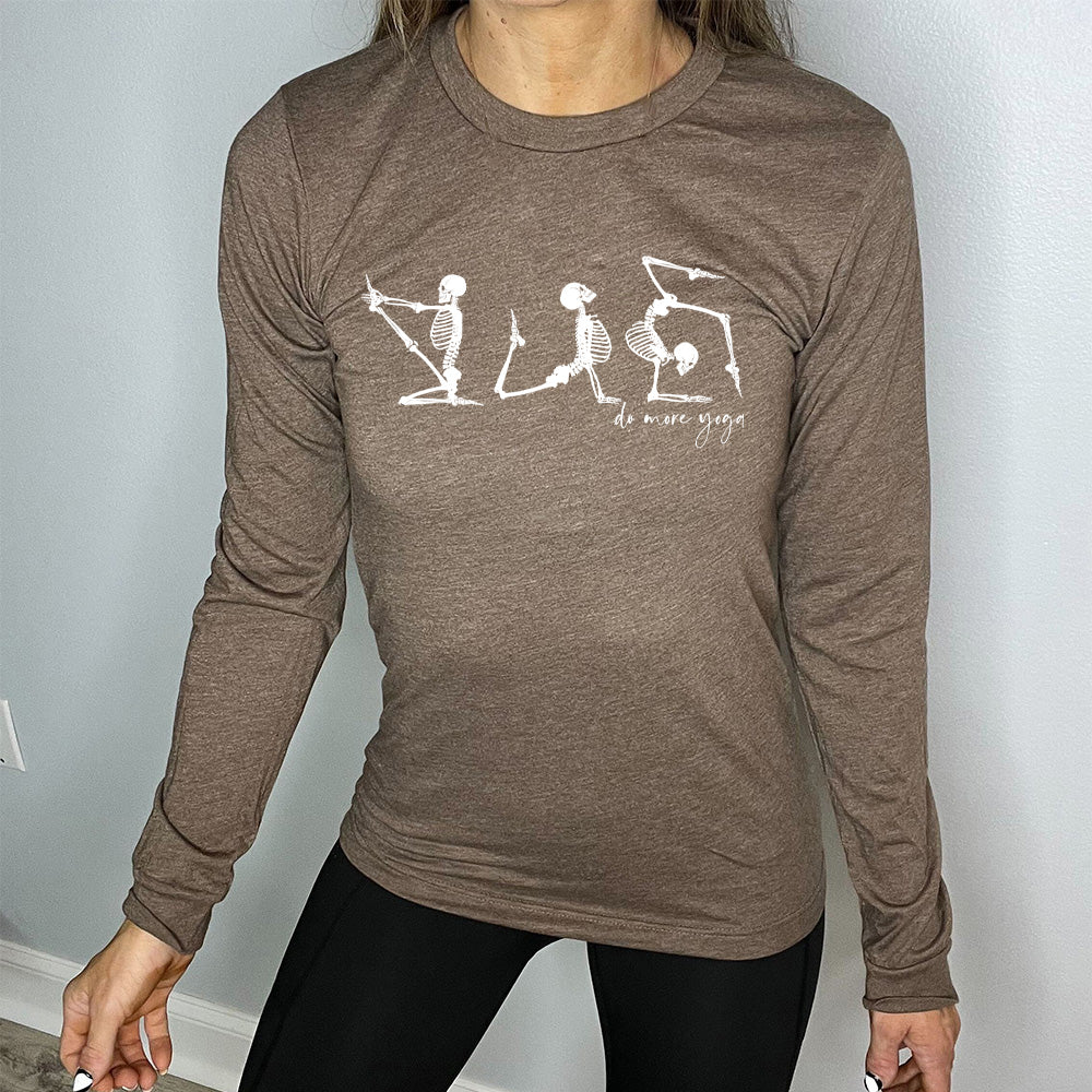 heather brown long sleeve shirt with three skeleton graphics doing yoga, with the small words underneath saying "do more yoga"