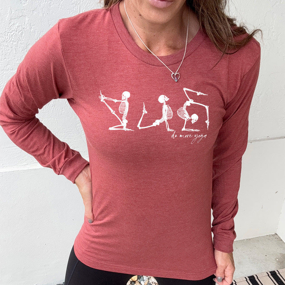 heather clay long sleeve shirt with three skeleton graphics doing yoga, with the small words underneath saying "do more yoga"