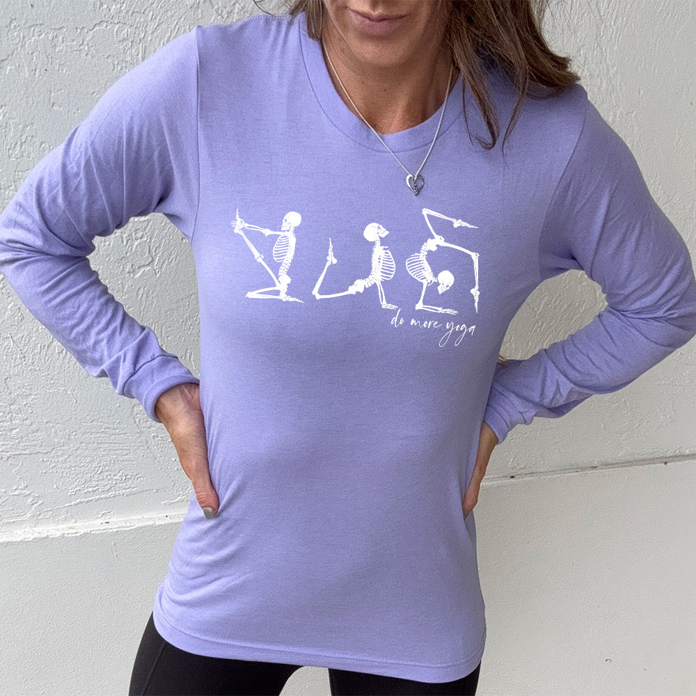 heather dark lavender long sleeve shirt with three skeleton graphics doing yoga, with the small words underneath saying "do more yoga"