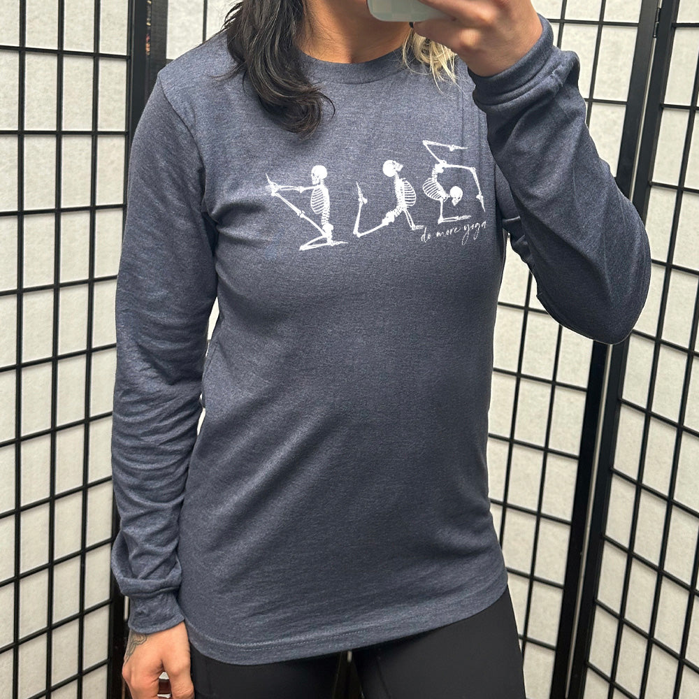 heather navy long sleeve shirt with three skeleton graphics doing yoga, with the small words underneath saying "do more yoga"