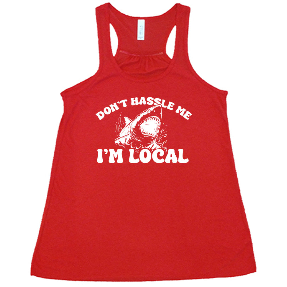 Red colored flowy tank with a shark graphic on it that says "Don't Hassle Me I'm Local"