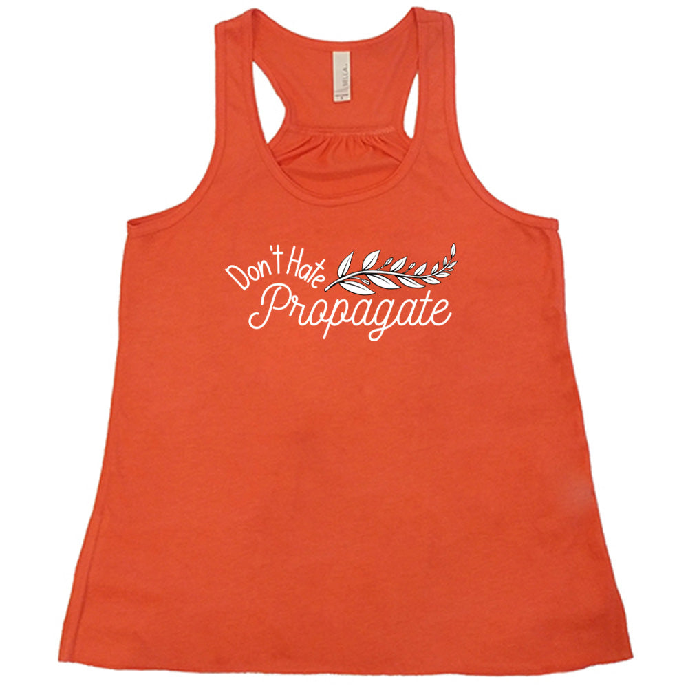 Coral colored flowy tank with a plant graphic on it that says "Don't Hate, Propagate"
