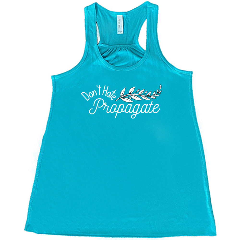 Teal colored flowy tank with a plant graphic on it that says "Don't Hate, Propagate"