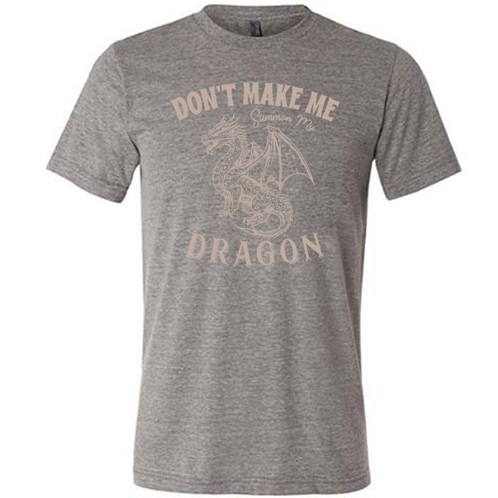 grey unisex tee with the words "don't make me summon my dragon" on it, surrounding the graphic of a fierce-looking dragon