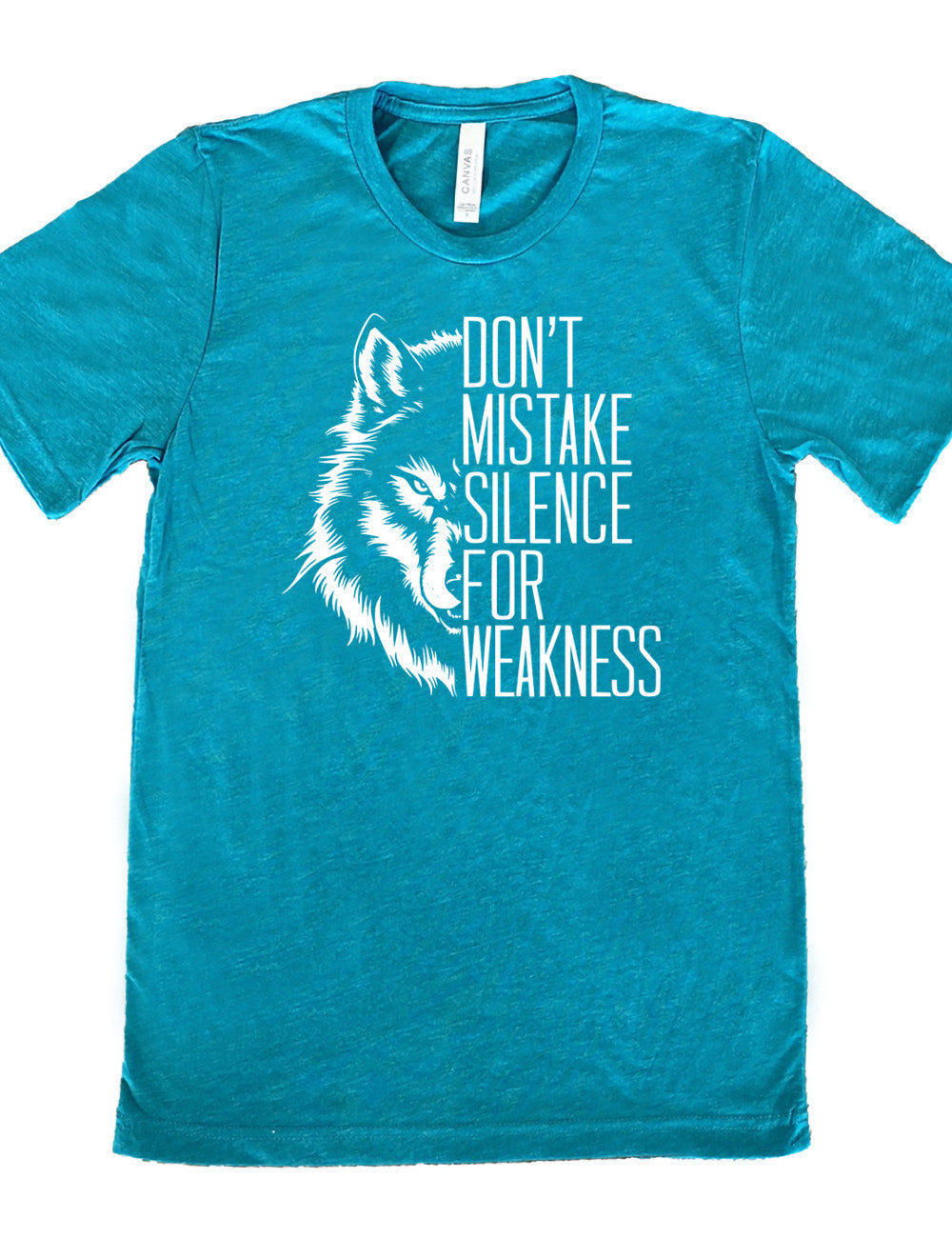 teal unisex tee with the graphic of half a wolf's head, and the words "don't mistake silence for weakness" making up the other half