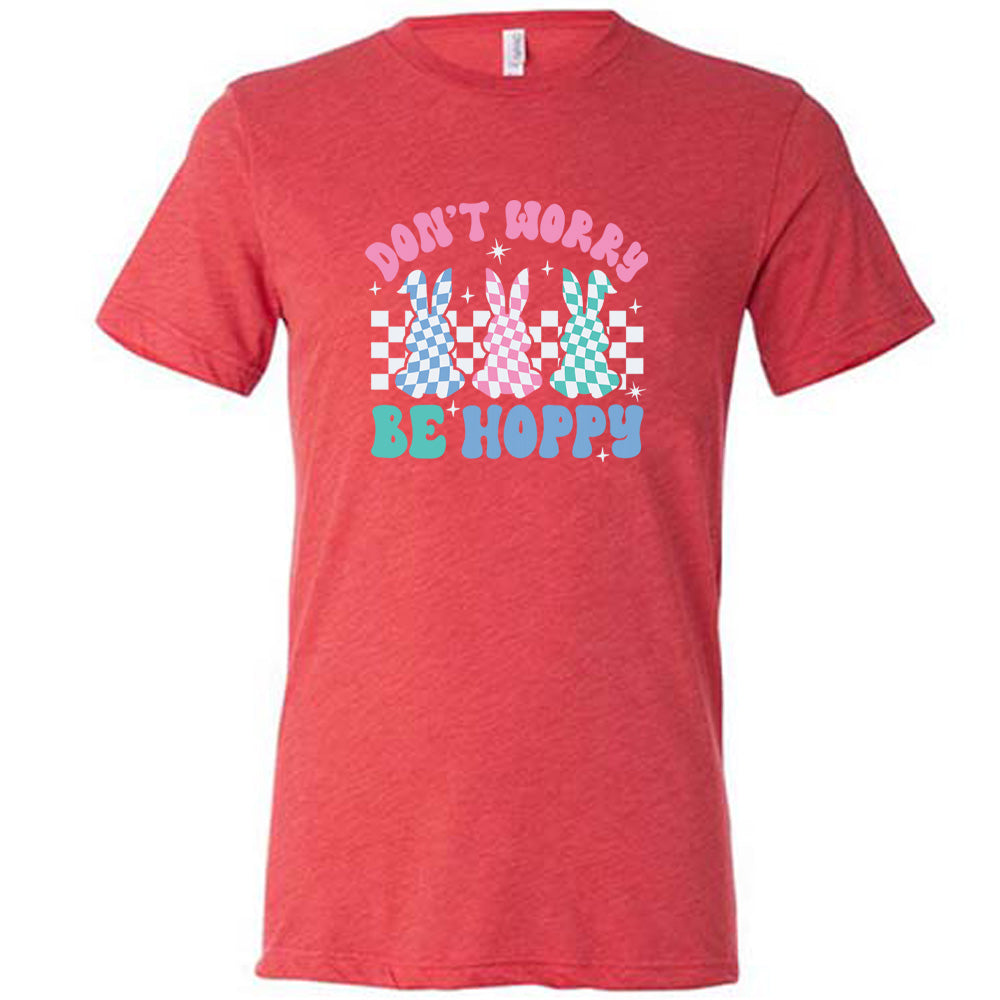 Red colored shirt with a checkered bunny graphic on it that says "Don't Worry Be Hoppy"