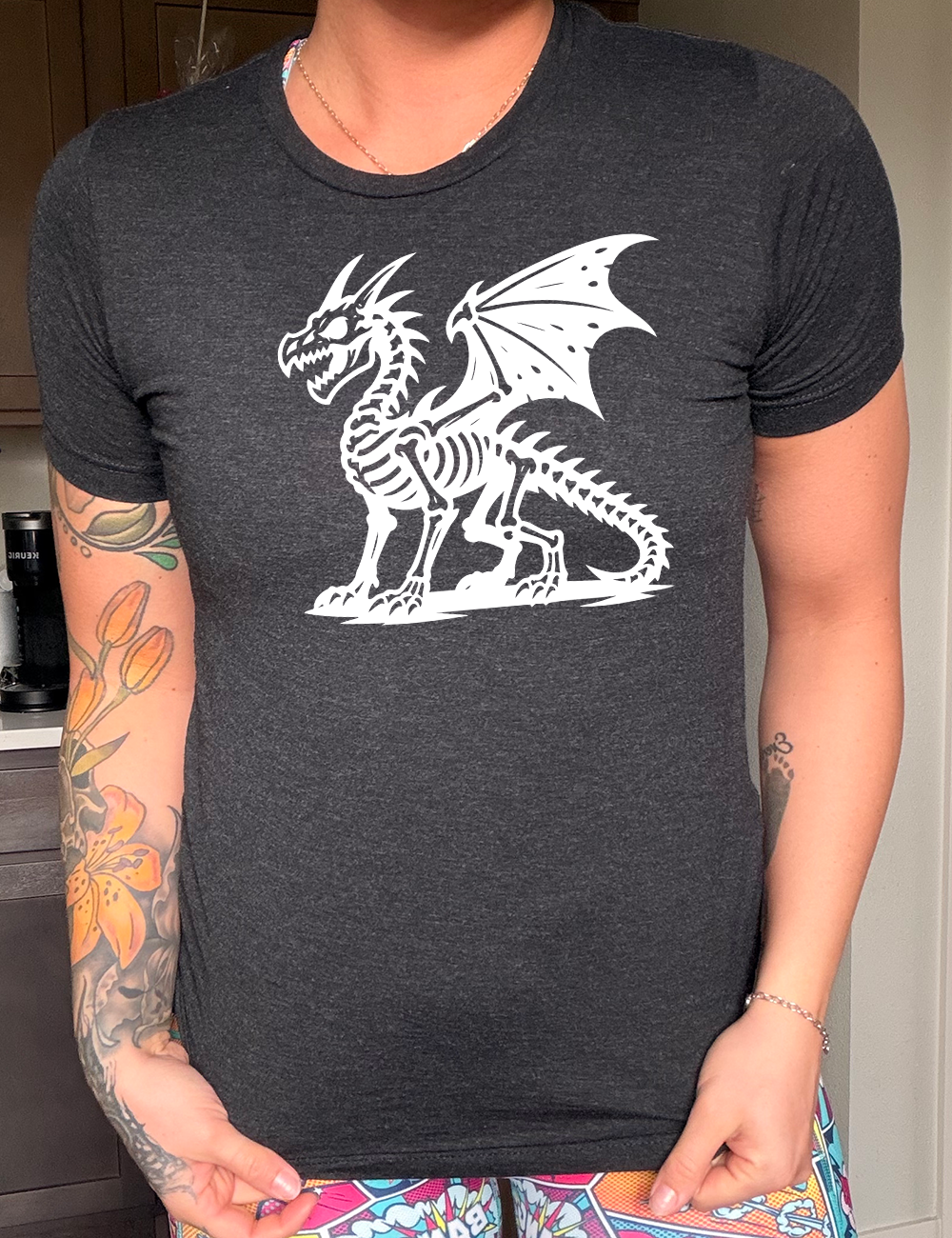 black unisex tee with the large graphic of a dragon, and its body is its skeleton