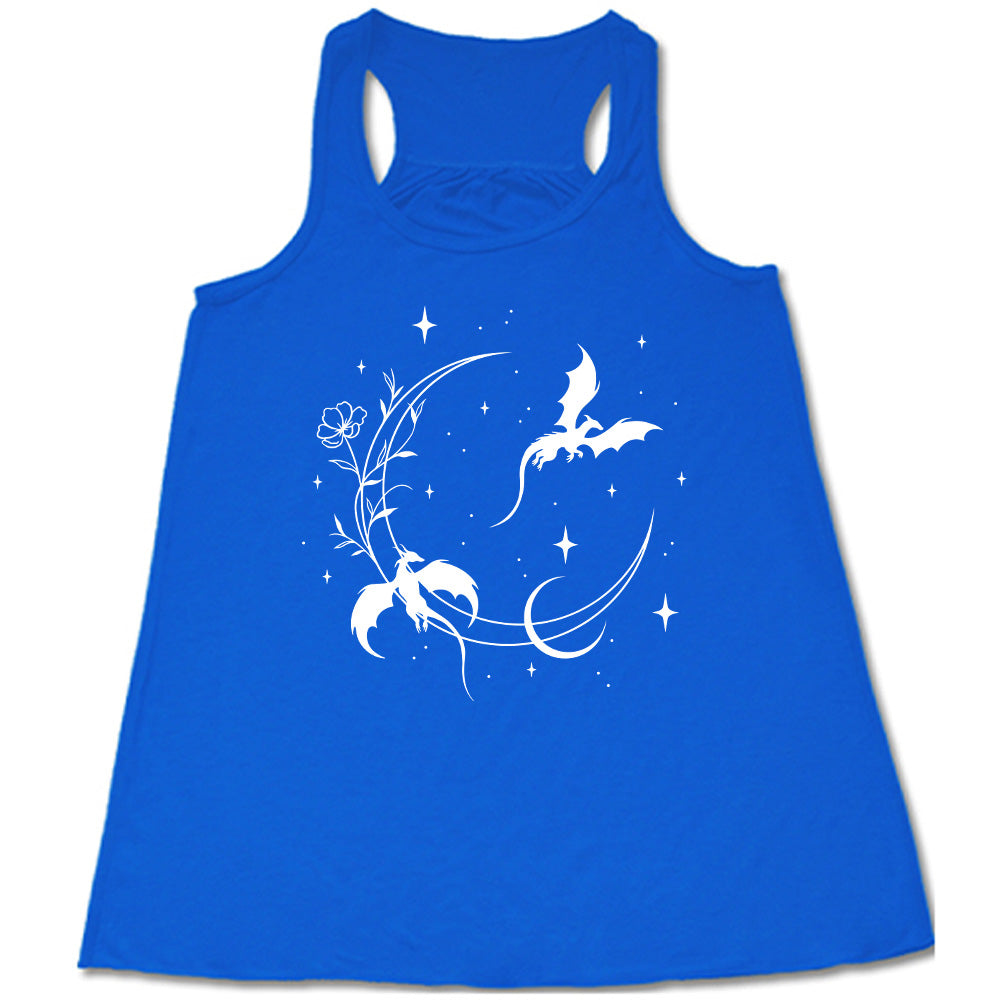 blue racerback flowy tank with the graphic of a large crescent moon, with a flower lining it, two dragons flying, another smaller moon, and many small stars