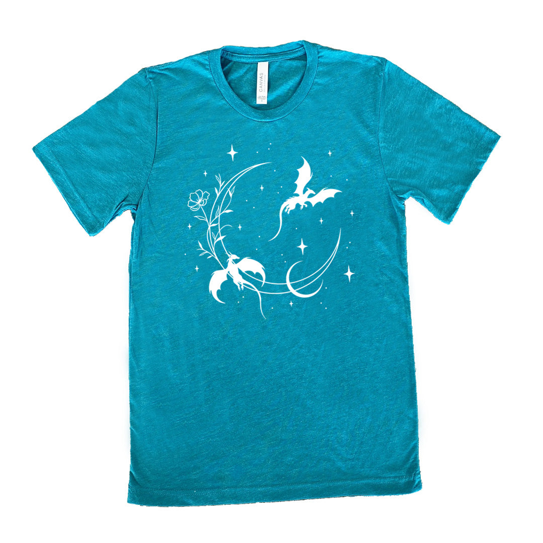 teal unisex tee with the graphic of a large crescent moon, with a flower lining it, two dragons flying, another smaller moon, and many small stars