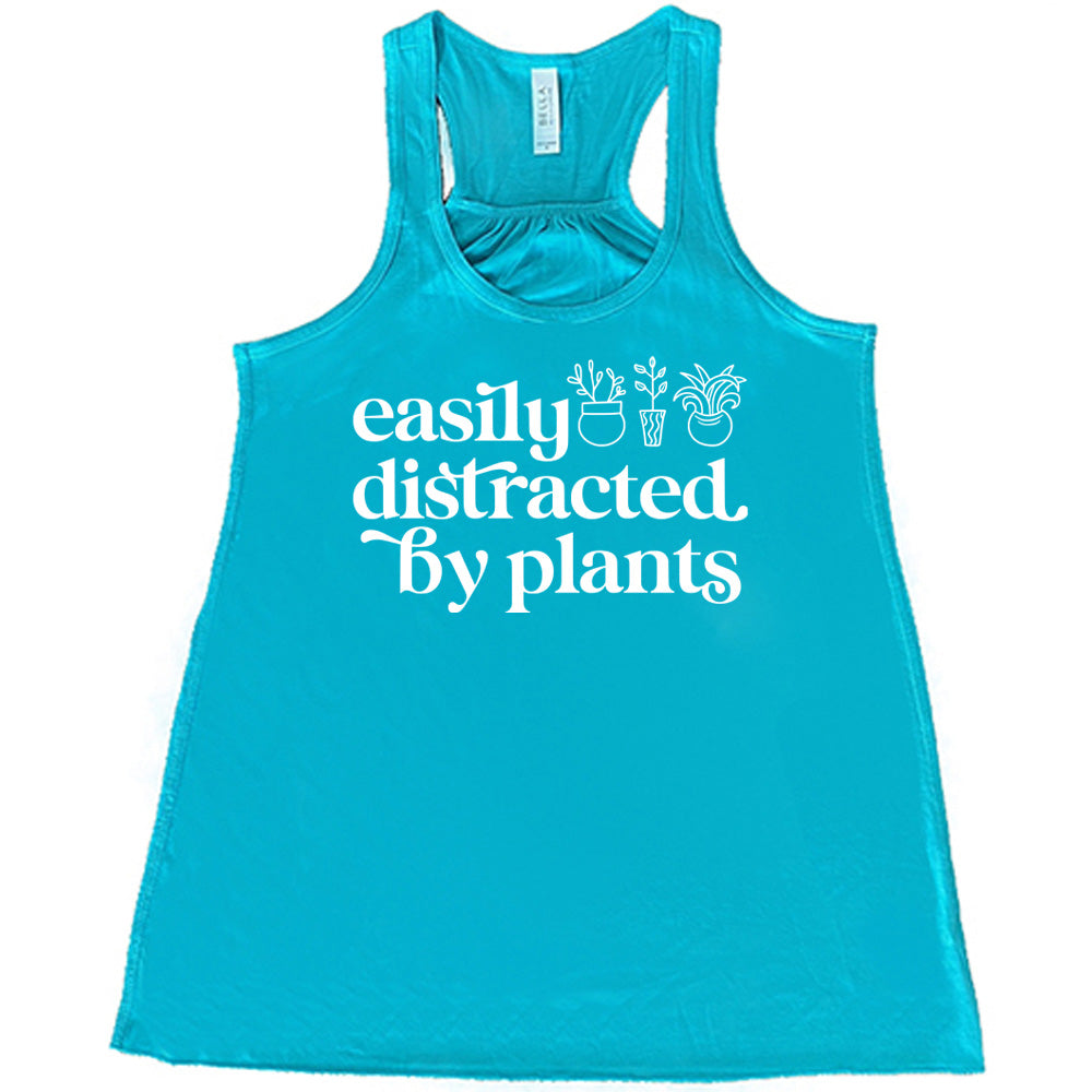 Teal colored flowy tank with a potted plant graphic on it that says "Easily Distracted By Plants"