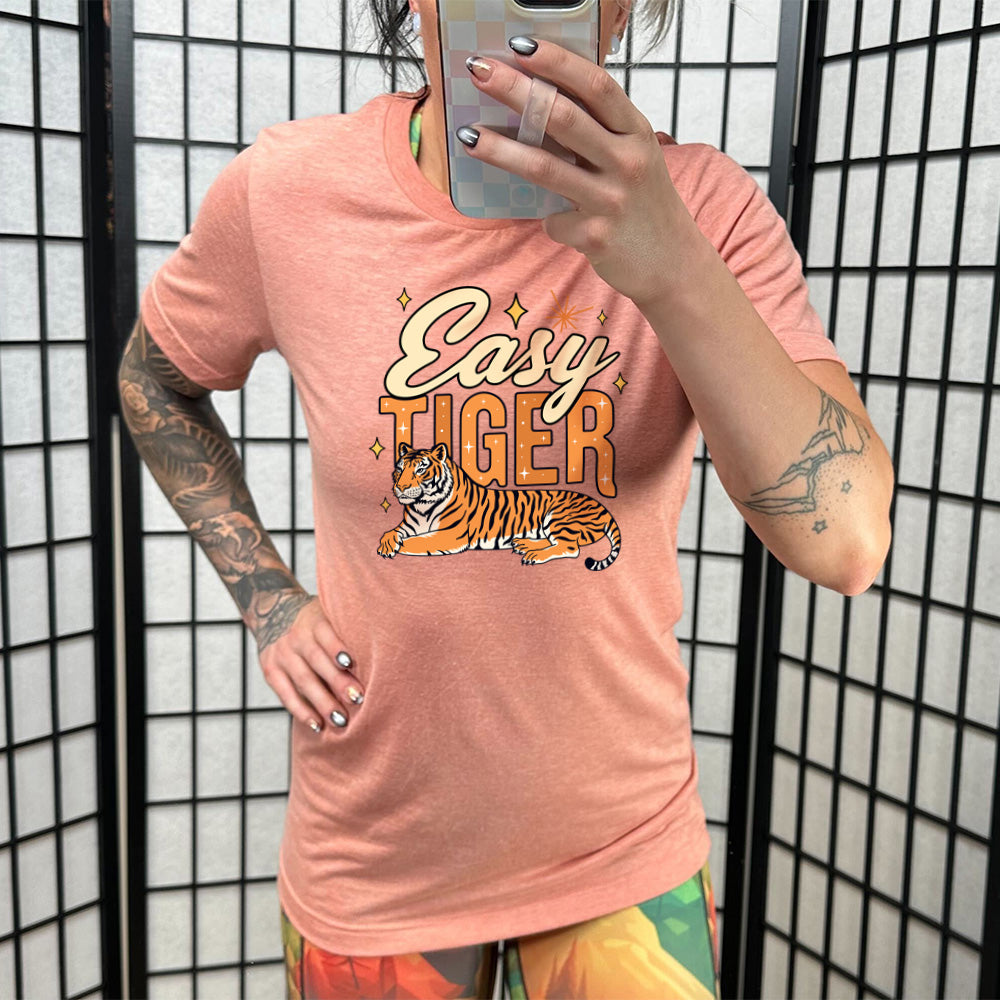 Sunset colored shirt with a tiger graphic on it that says "Easy Tiger"