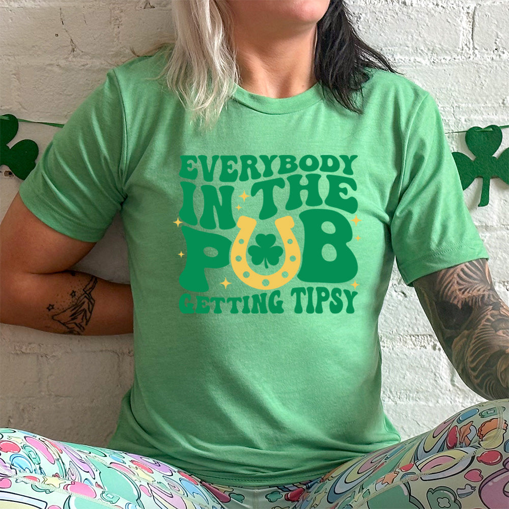 green shirt with the quote "Everybody In The Pub Getting Tipsy" on it