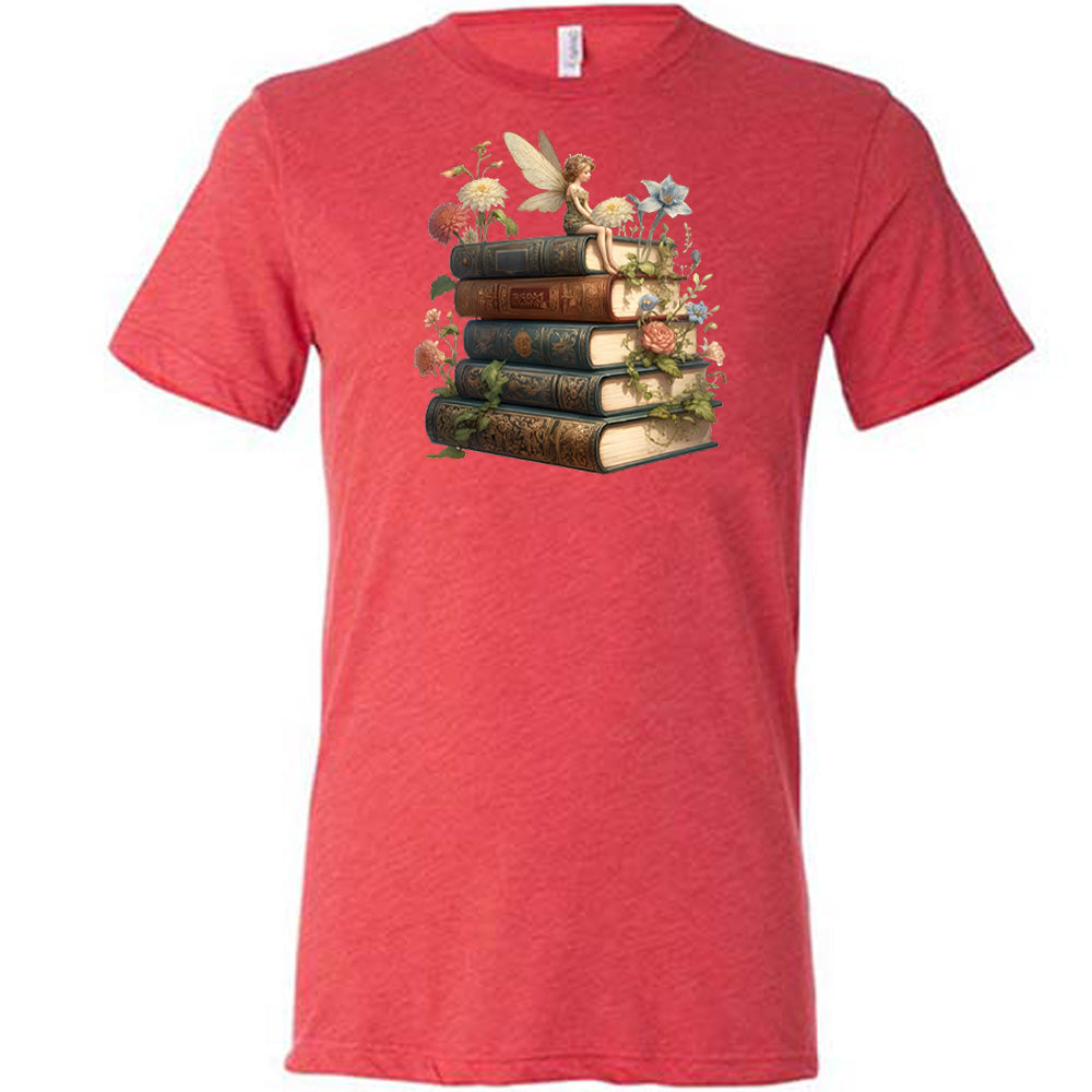 red shirt with a fairy sitting on books graphic in the center