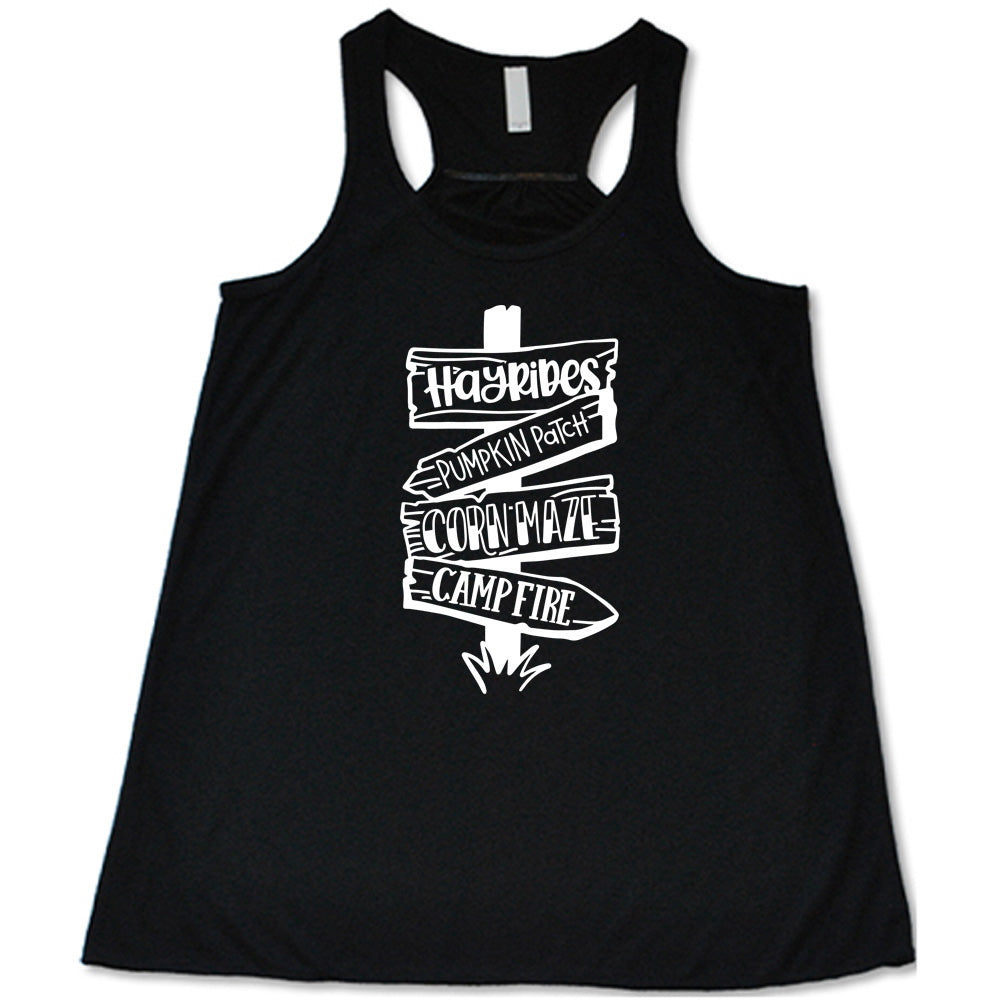 Black colored flowy tank with fall activities signpost graphic on it that says "Hayrides, Pumpkin Patch, Corn Maze, Campfire"