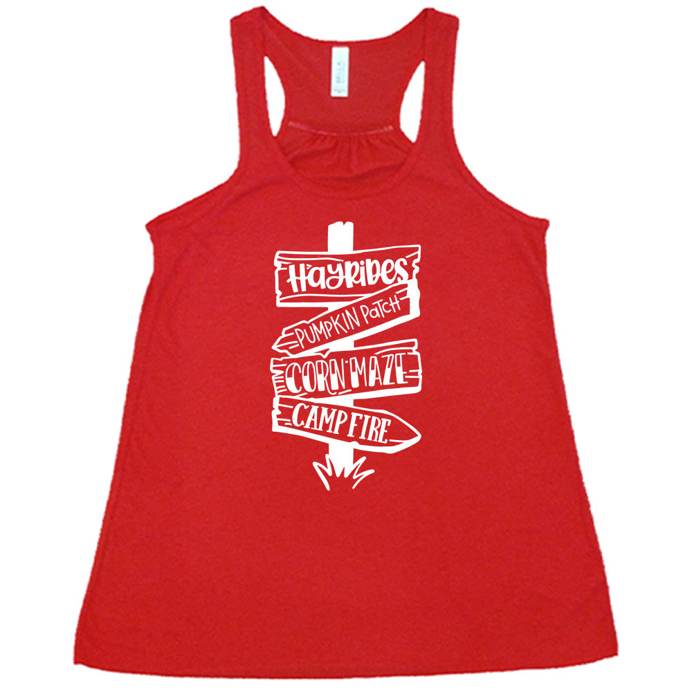 Red colored flowy tank with fall activities signpost graphic on it that says "Hayrides, Pumpkin Patch, Corn Maze, Campfire"