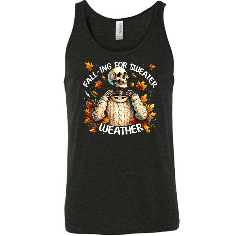 Black colored tank with fall leaves and skeleton wearing a sweater graphic on it that says "Fall-ing For Sweater Weather"