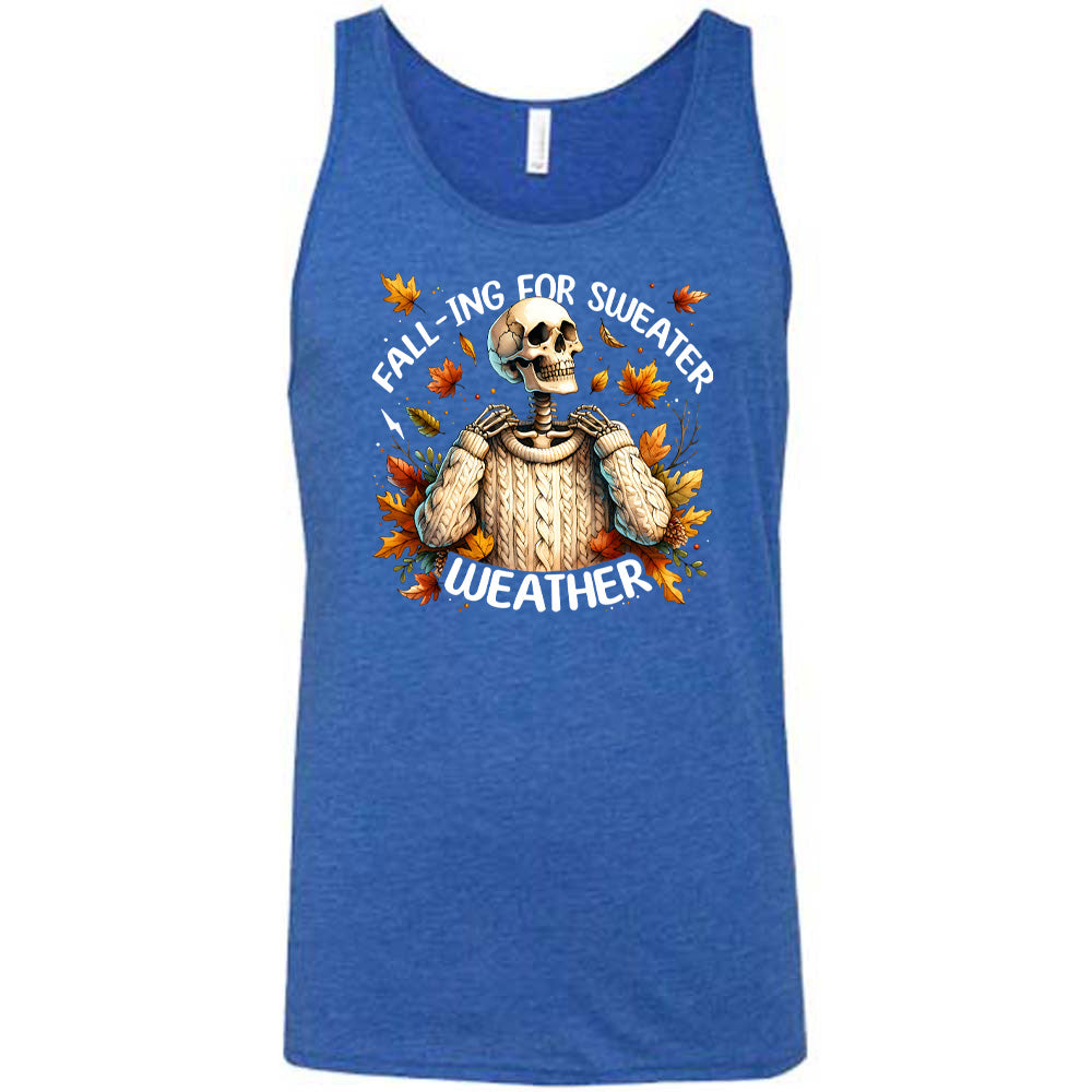 Blue colored tank with fall leaves and skeleton wearing a sweater graphic on it that says "Fall-ing For Sweater Weather"