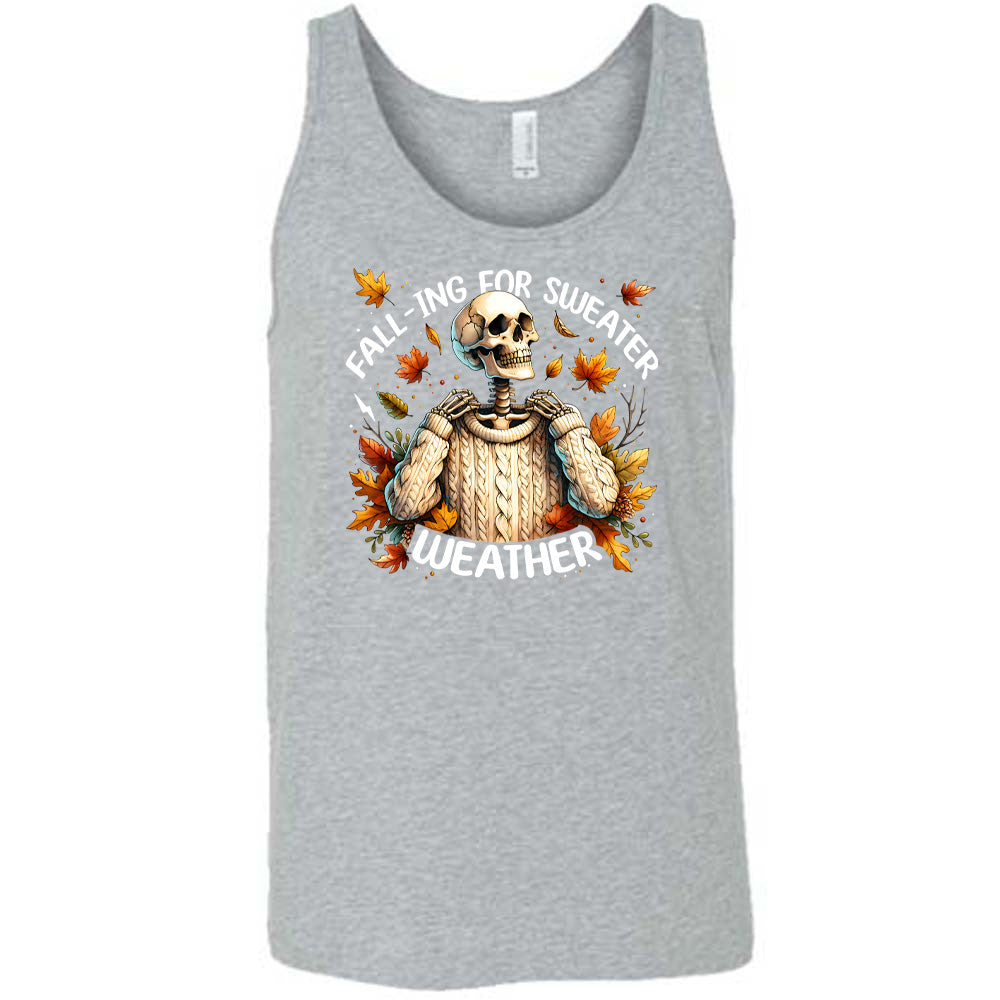 Grey colored tank with fall leaves and skeleton wearing a sweater graphic on it that says "Fall-ing For Sweater Weather"