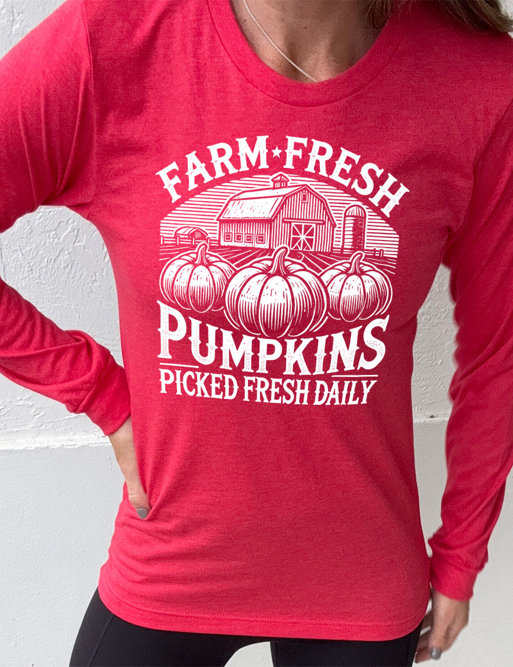 heather red long sleeve shirt with the words "farm fresh pumpkins picked fresh daily" around the graphic of a barn in the background and three pumpkins in the foreground