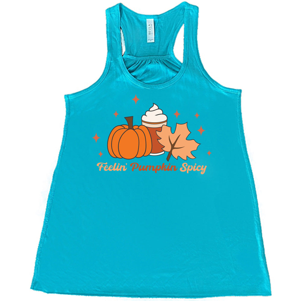Teal colored flowy tank with pumpkin, coffee, and fall leaf graphic on it that says "Feelin' Pumpkin Spicy"