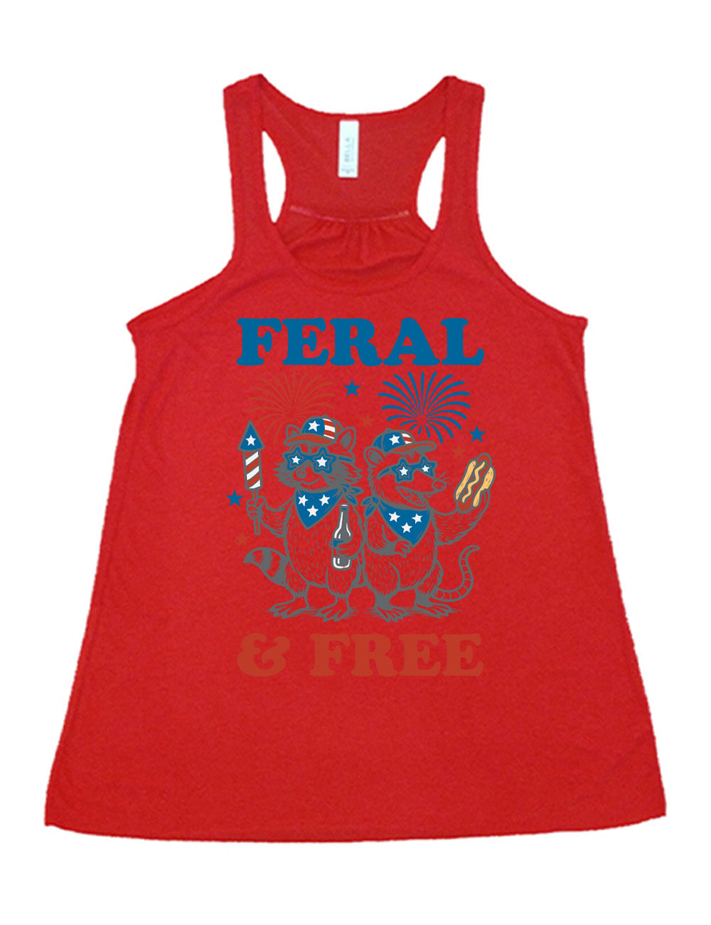 red flowy racerback tank with the words "feral & free" around the graphic of two racoons, both wearing American flag hats, sunglasses, and bandanas, one holding a firework and a beer bottle, the other holing a hotdogs, and fireworks going off above, and a few little stars