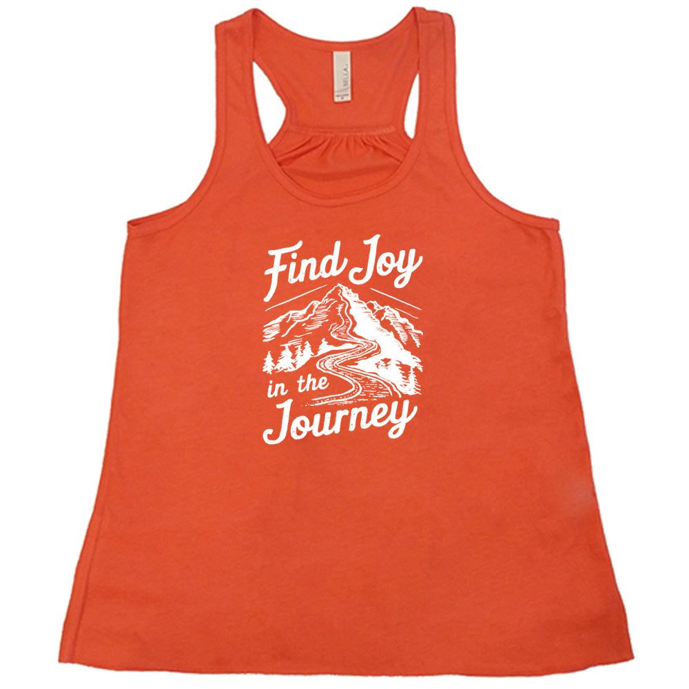 Coral colored flowy tank with a mountain road graphic on it that says "Find Joy In The Journey"