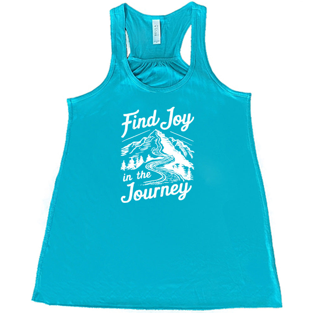 Teal colored flowy tank with a mountain road graphic on it that says "Find Joy In The Journey"
