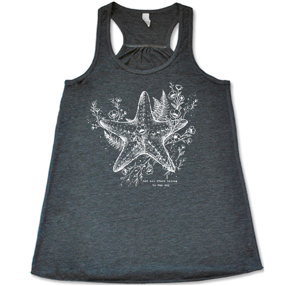 grey racerback flowy tank with the graphic of a very detailed starfish among sea plants and flowers, with little bubbles, and the small words underneath it all that say "not all stars belong to the sky"