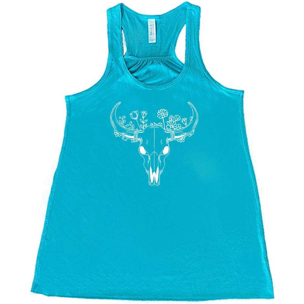 Teal colored flowy tank with a floral cow skull graphic on it