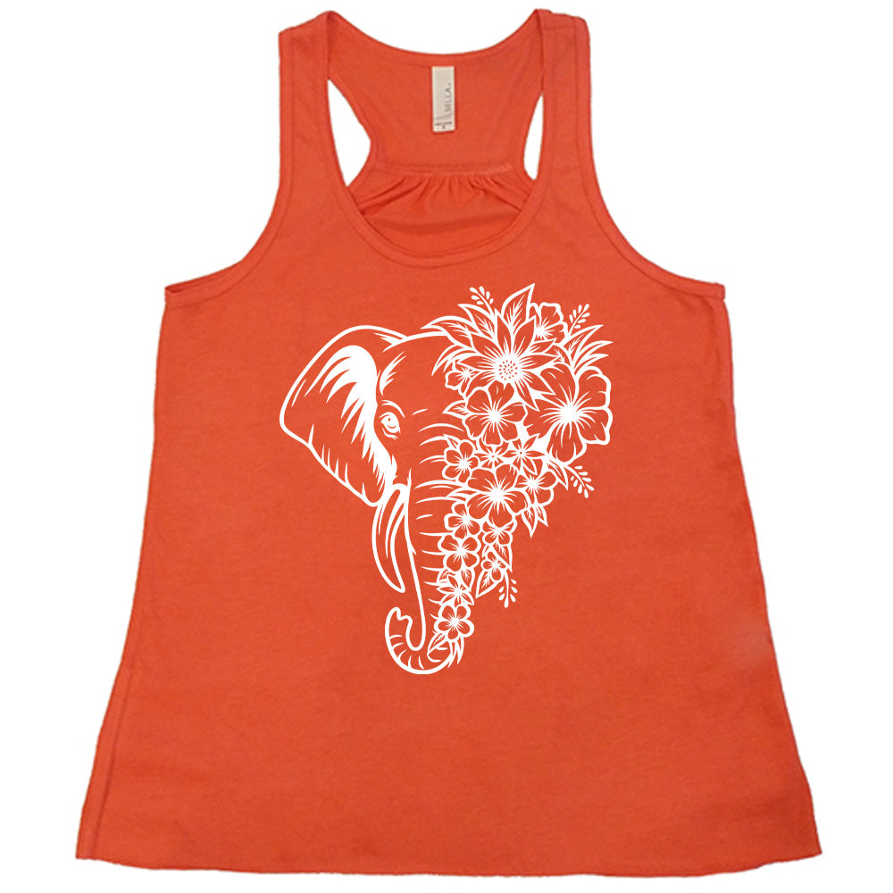 coral racerback tank with the graphic of an elephant's head, with half of its head made up only of tropical flowers