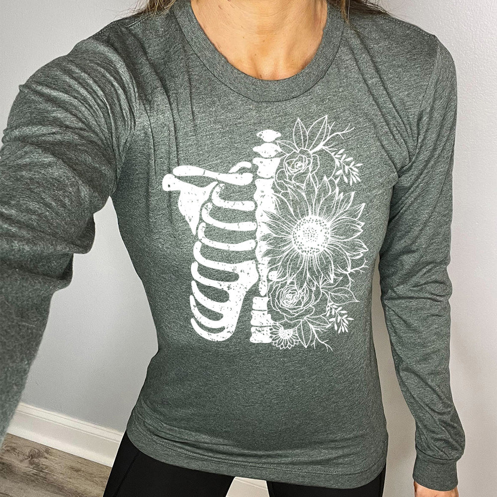 heather forest long sleeve shirt with the graphic of a skeletal ribcage, with half of it being made up of flowers