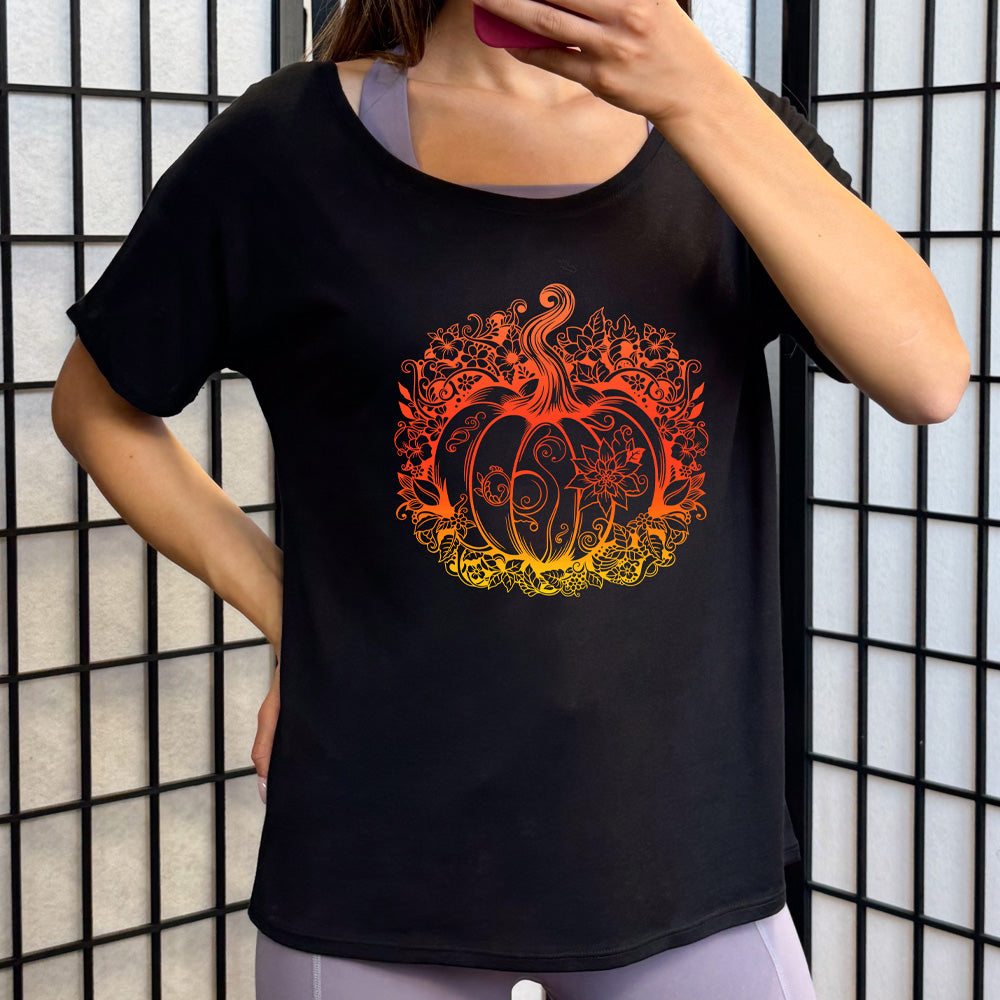 Person wearing a black t-shirt with a colorful pumpkin design on it