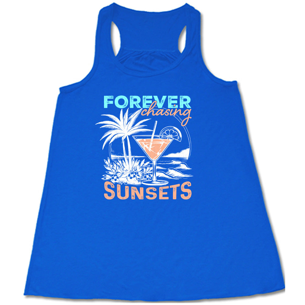 Blue colored flowy tank with a drink on the beach graphic on it that says "Forever Chasing Sunsets"