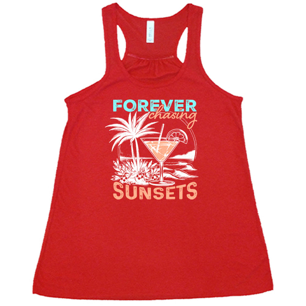 Red colored flowy tank with a drink on the beach graphic on it that says "Forever Chasing Sunsets"