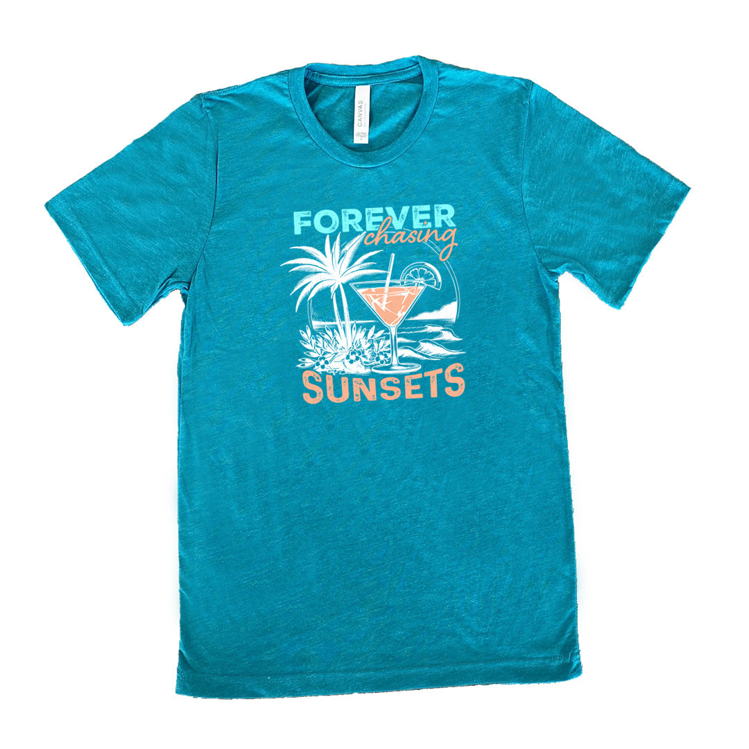 Teal colored shirt with a drink on the beach graphic on it that says "Forever Chasing Sunsets"