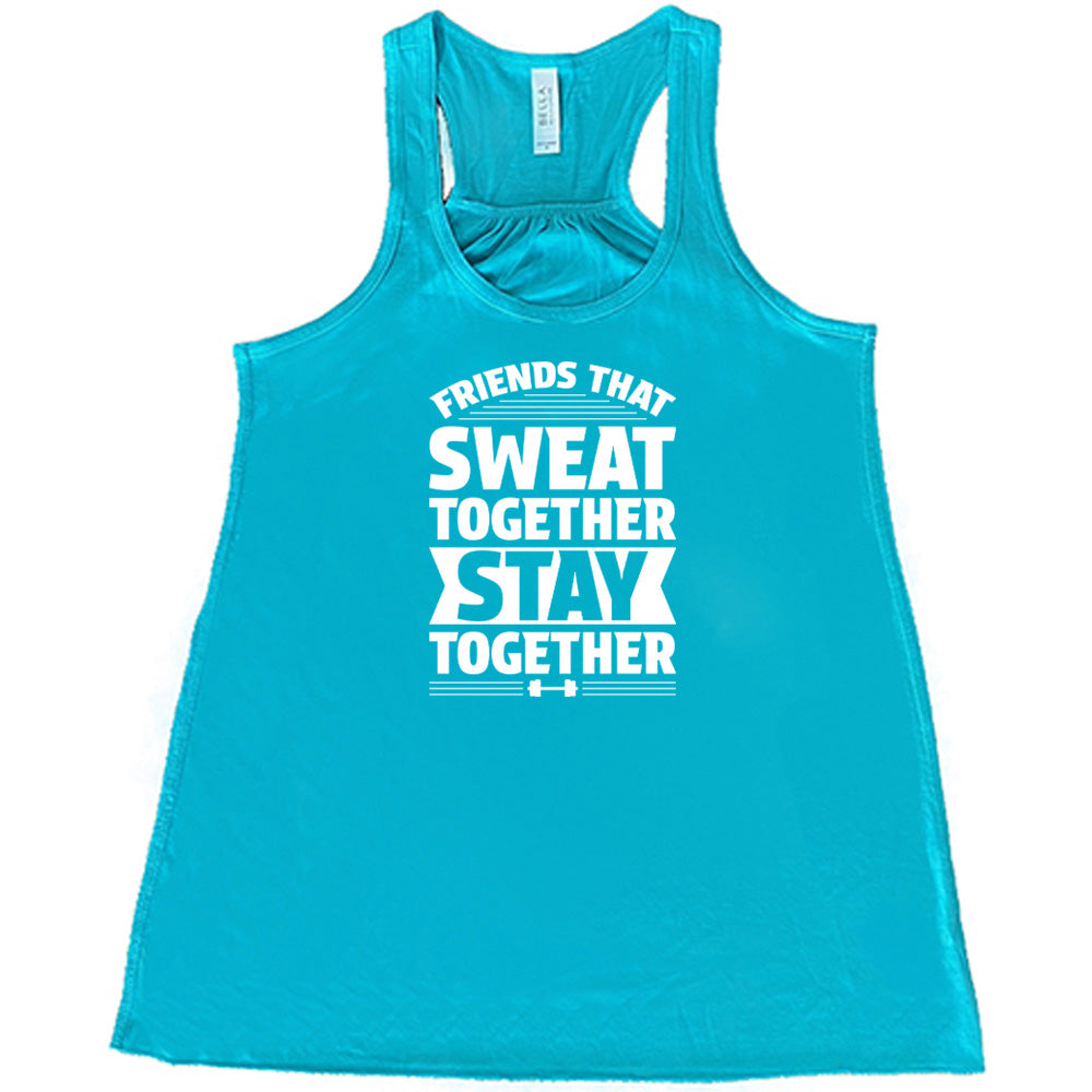 Teal colored flowy tank that says "Friends That Sweat Together Stay Together"